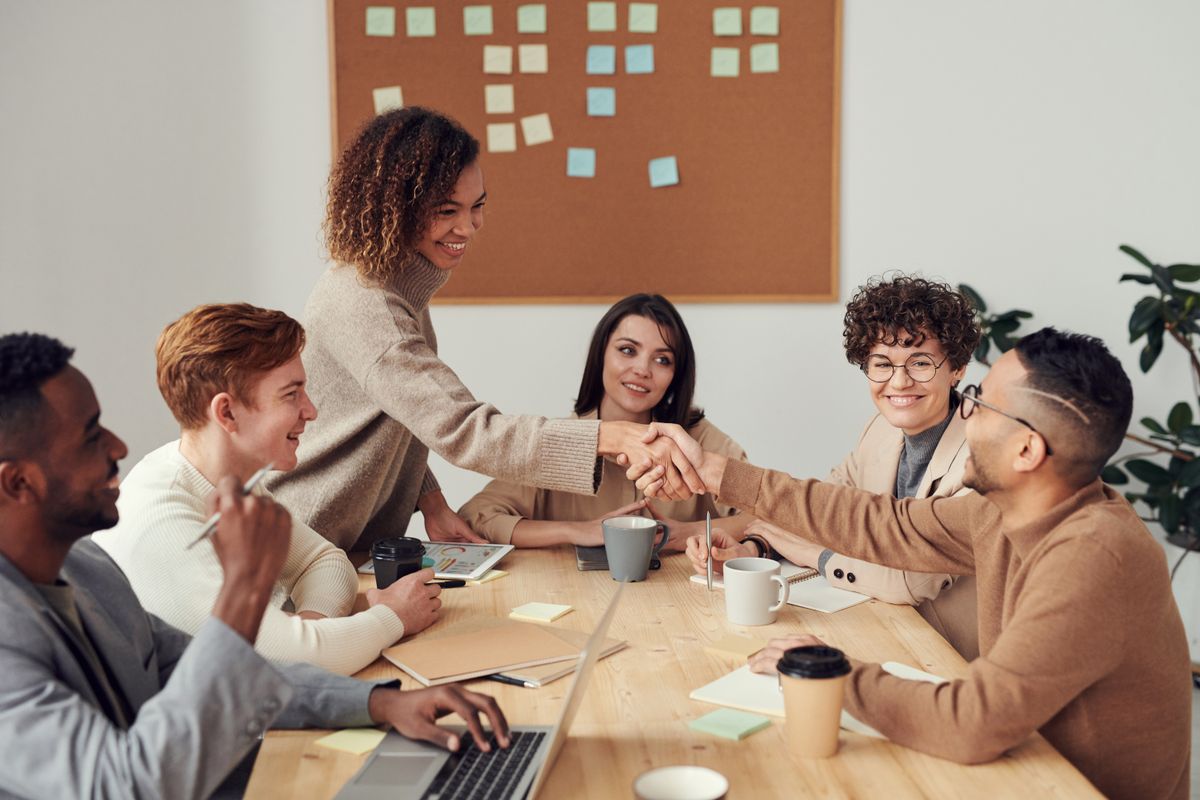 A team reviewing work together on a laptop